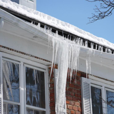 Sagging aluminum gutter showing the "smile" effect caused by heavy ice dam weight in Columbus, Ohio