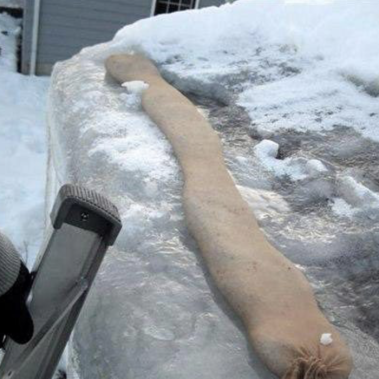 Using a calcium chloride sock to melt a drainage channel through a roof ice dam.